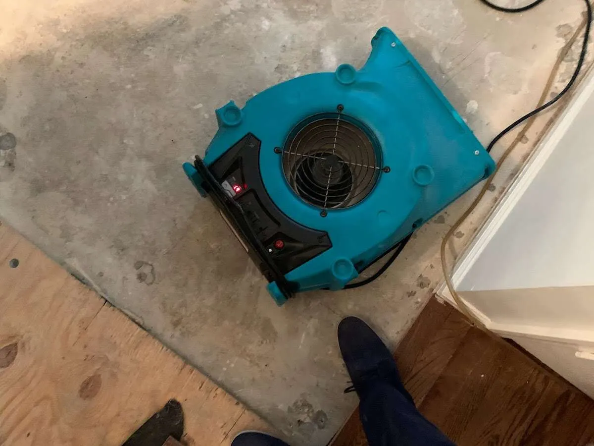 Air mover drying subfloor during Leak Detection & Repair in Fairfield Glade